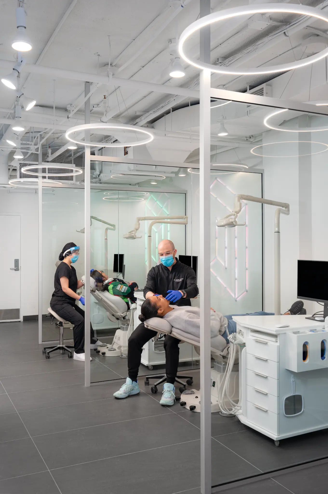 Modern orthodontic treatment area with ring lights